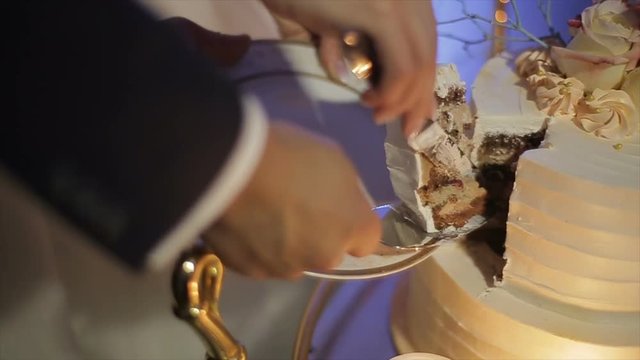 Close up of bride and groom cutting their wedding cake.