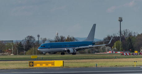 Fototapeta premium Landing of blue and white airplane in capital Prague