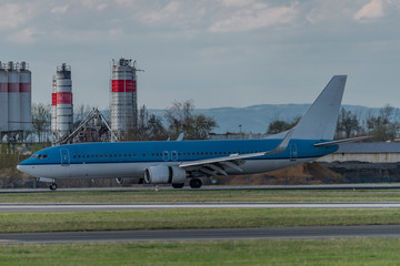 Fototapeta premium Landing of blue and white airplane in capital Prague
