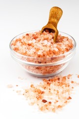 Fototapeta na wymiar Pink salt from the Himalayas on white background. Pile of pink Himalayan salt. Sale of spices
