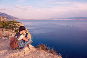 Fototapeta premium Young beautiful girl traveling along the coast of the Mediterranean Sea.