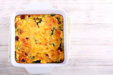 Savoy cabbage, sausages and cheese gratin