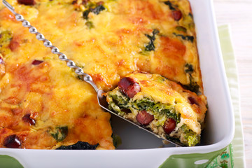 Savoy cabbage, sausages and cheese gratin