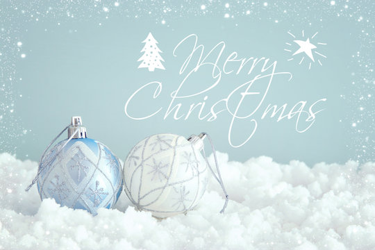 Image of christmas festive tree white ball decoration in front of pastel blue background background.