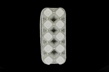 Cardboard empty tray for ten pieces eggs isolated on black background