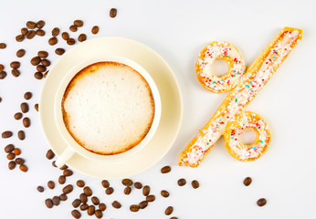 Percent sign in the form of cookies and a Cup of coffee on a white background with space for text. The concept of discounts, sales