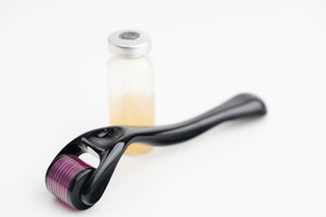 Dermaroller needle with serum in glass bottle. Anti wrinkle skin care.