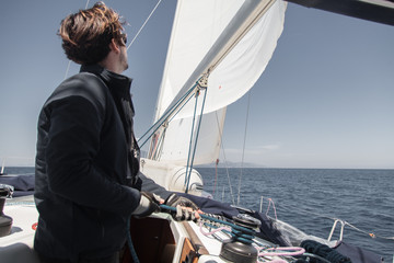 Sailor sets sail on a sailing yacht.
