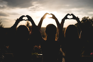 Rear view of girls with heart and love shape.