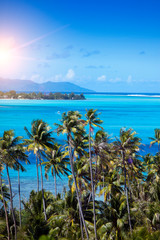 Blue lagoon of island Bora Bora, Polynesia. Mountains, the sea, palm trees.