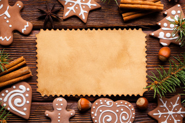 Blank paper card, gingerbread Christmas cookies and spices on wooden background