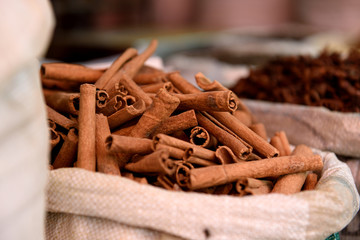 Side view of  basket of fresh raw Cinnamon Sticks, spice market, Jaipur, India