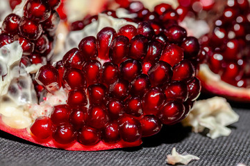 Red Background of Grain Red Grenades. Big ripe red granets or garnets. Vegetarian concept, organic vitamins. Organic and benefit garnet fruit.