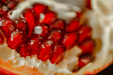 Red background of grain red grenades. Big ripe red granets or garnets. Vegetarian concept, organic vitamins. Organic and benefit garnet fruit.