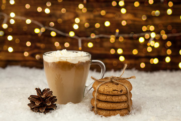 Cup of coffee and American cookies on winter Christmas background