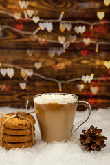 Cup of coffee and cookies on winter Christmas background