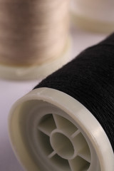 Bobbins with threads on the background of an old wooden table