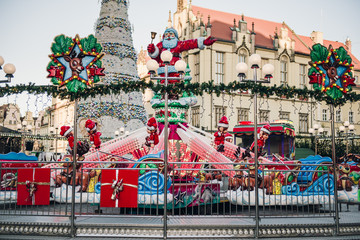 Traditional Christmas market in Europe. Carousel decorated with lights. Christmas fair concept.