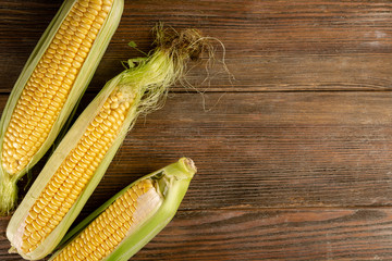 Corn cob on wooden background
