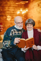 An elegant old couple are celebrating Christmas