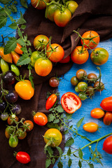 Fresh tomato ripe and green on wood