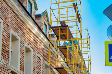 Fototapeta premium Scaffolding on the background of an old building