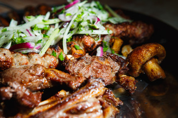 Lula kebab with vegetables. Minced mutton chop on the big steel plate