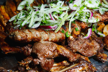 Lula kebab with vegetables. Minced mutton chop on the big steel plate