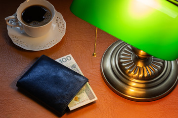 Poland money, Zloty, on a stylish desk lit with a banking lamp