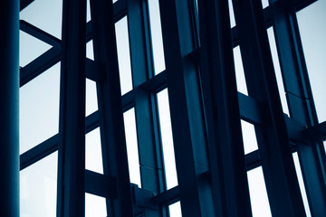 Steel and glass structure with metal framework of an office building exterior fragment. Abstract modern architecture background.