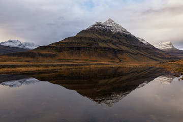 Fototapeta na wymiar Bulandstindur peak reflected in a lake, Djupivogur, Iceland