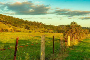 Fototapeta na wymiar Sunset on rural fence and hills west of Picton town Australia