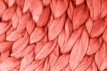 Abstract woven mat texture background living coral color. Trendy concept color of the year.