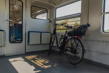 Papier Peint photo autocollant Vélo Electric bicycle in czech train in sunny spring afternoon