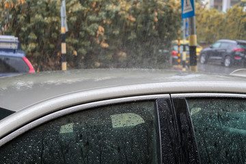 Fototapeta na wymiar Winter in Israel: Downpour, Heavy rain floods cars and road, raindrops on glass and metal