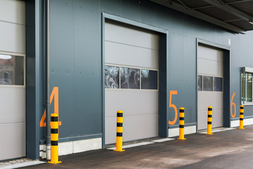 Warehouse gates with numbers. Logistic, storage, shipment, transportation and loading concept. - obrazy, fototapety, plakaty