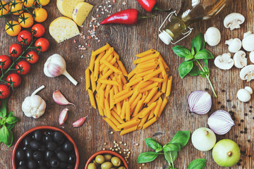 Stylish composition of italian ingredients and food on the vintage wooden table. Culinary backgrounds. Top view. Heart shape.