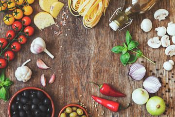 Modern composition of traditional italian food and ingredients on the vintage wooden table in the kitchen. Italian taste and look. Top view. Copy space.