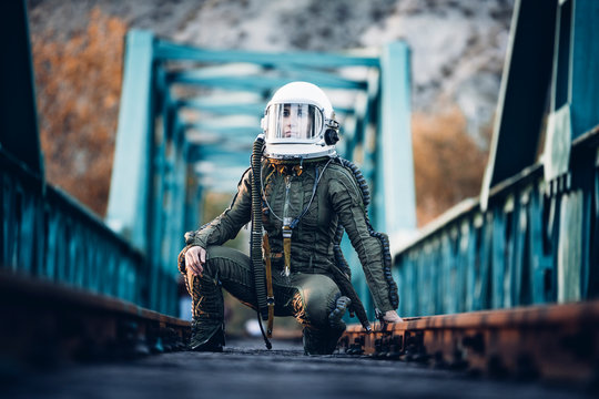 Female astronaut on train tracks