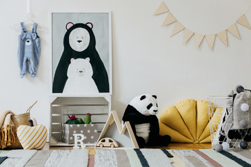 Stylish scandinavian newborn baby room with colorful toys, teddy bears, pillows and blankets....