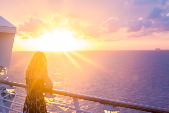 Blond watching sunset from cruise ship in caribbean sea near Philipsburg, St Martin