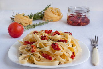 Fettuccine pasta with sun-dried tomatoes and various herbs.