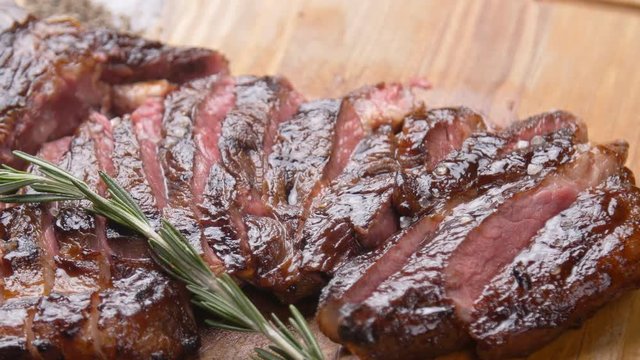 Cooking concept. Grilled marinated beef flank steak on wooden board