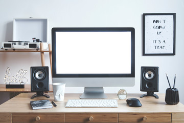White scandinavian interior of home creative desk with mock up computer screen, photo frame, speakers, office accessories and gramophone. Minimalistic space for work, hobby and listen music. 