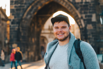man in front of charles bridge in prague