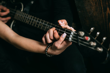 Fototapeta na wymiar On the music waves. Couple in love play duets. Couple of musicians enjoy playing music. Male and female hands play the electric guitar. Couple of guitar players. Instrumental music live