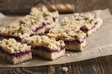 Raspberry bars on rustic wooden table