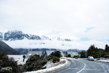 View of a road in Mount Cook Village covered with white fresh snow after a snowy day.