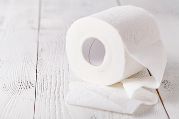 Toilet paper roll on the white wooden table