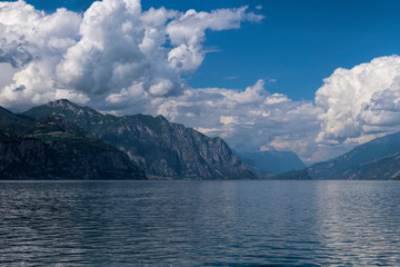 View of Lake Garda and mountains on a cloudy day.